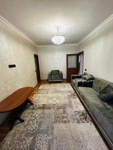 a living room with a couch and a table at Goris Central House in Goris