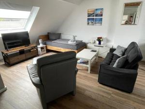 a living room with two chairs and a couch at Logger in Emden