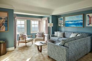 a living room with a couch and a table at Bournemouth Highcliff Marriott Hotel in Bournemouth