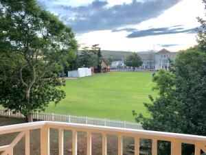 a view of a large green field from a balcony at Beautiful 3 bedroom flat in Grahamstown
