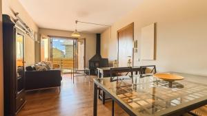 a living room with a glass table and a couch at Chez Bonheur in Osséja +9 photos