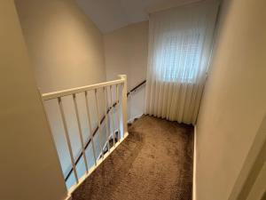 a staircase with a white railing and a window at LUXURY Home Axel in Axel