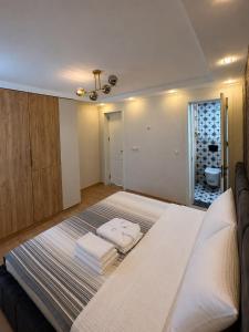 a bedroom with a bed with towels on it at Cherry Guesthouse in Tsalka