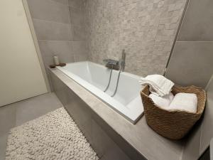 a bathroom with a tub and a basket of towels at LUXURY Home Axel in Axel +13 photos