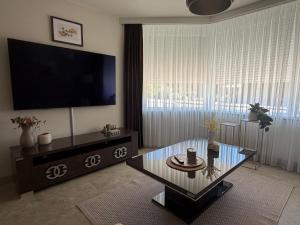 a living room with a television and a coffee table at LUXURY Home Axel in Axel