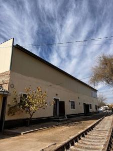 a building with a train track in front of it at Mezbon in Termiz