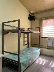 a bedroom with two bunk beds in a room at Mezbon in Termiz