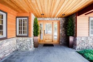 a front door of a home with a wooden ceiling at Luxury Cabin on Golf Course / Private Spa & Launch in Prattville