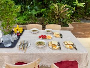 a table with plates of breakfast food on it at Kharin guesthouse in Nakhon Phanom