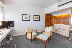 a living room with a couch and a table at Hotel Eurosol Leiria & Jardim in Leiria