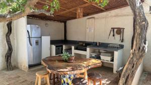 an outdoor kitchen with a table and a refrigerator at Casa Bella Mya in Taganga