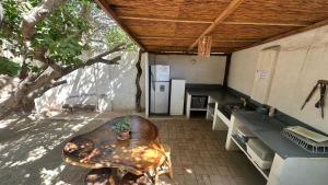 a room with a kitchen with a table and a refrigerator at Casa Bella Mya in Taganga +20 photos
