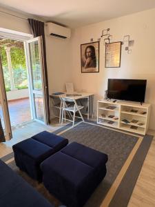 a living room with a couch and a tv and a table at Villa Gloria in Dubrovnik