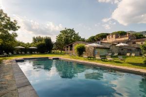 a swimming pool in the yard of a house at Monastero San Silvestro in Cortona