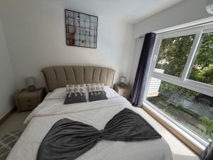 a bed in a bedroom with a large window at livejaco405A in Jacó +10 photos