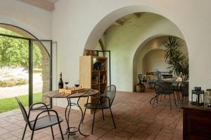 a living room with a table and chairs and a dining room at Monastero San Silvestro in Cortona