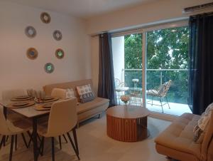 a living room with a couch and a table at livejaco405A in Jacó
