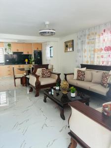 a large living room with couches and a table at Carrasco D in Nagua