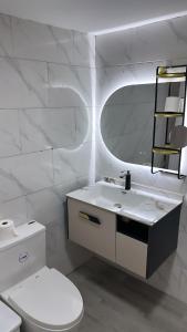 a white bathroom with a sink and a toilet at Carrasco D in Nagua