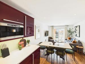a kitchen and living room with a table and chairs at Westminster Residences by Apt in London