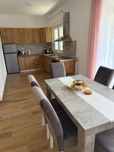 a kitchen and dining room with a table and chairs at Villa Sveta Obitelj in Međugorje +23 photos