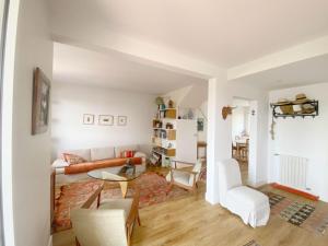 a living room with a couch and a table at Maison basque familiale Eguski Alde in Saint-Jean-de-Luz