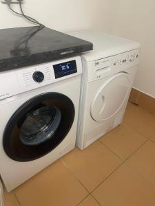 a white washing machine sitting in a kitchen at Jagger Green Retreat in Greetland