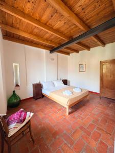a bedroom with a bed and a wooden ceiling at Olcium Holiday Rooms in Mandello del Lario