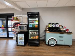 a food cart in a store with a refrigerator at Spark By Hilton Lake George Outlets in Lake George