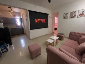 a living room with a netflix sign on a wall at Cinema Experience -Premium Studio in Karnal