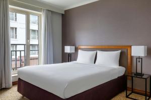 a bedroom with a large bed and a large window at Marriott Executive Apartments Brussels in Brussels
