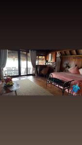 a bedroom with a bed and a table in a room at Tiare and Turtle in Bora Bora
