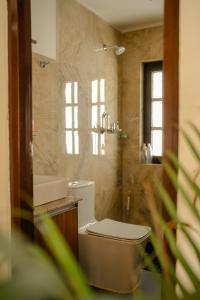 a bathroom with a toilet and a sink at Gakyi Homes Boudha in Kathmandu