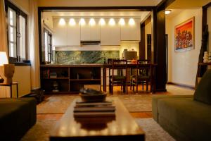 a living room with a table and a kitchen at Gakyi Homes Boudha in Kathmandu