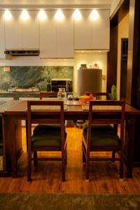 a kitchen with a large wooden table and chairs at Gakyi Homes Boudha in Kathmandu +25 photos