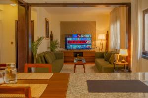 a living room with a couch and a tv at Gakyi Homes Boudha in Kathmandu