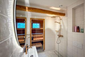 a bathroom with a shower and a mirror at Villa Maija 6 Topside in Hanko