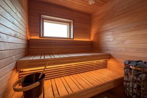 a sauna with a bench and a window at Villa Maija 6 Topside in Hanko