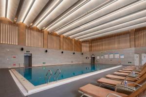 a large swimming pool with chairs around it at Crowne Plaza Beijing Badaling by IHG in Yanqing