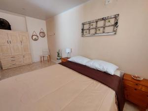 a bedroom with a large bed and a wooden dresser at Sol de Monte in San Miguel del Monte +17 photos