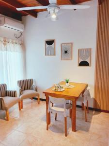 a dining room with a wooden table and chairs at Sol de Monte in San Miguel del Monte