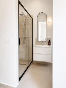 a bathroom with a shower and a sink and a mirror at ÉLÉGANT STUDIO et PARKING DANS BATIMENT HISTORIQUE in Saint-Tropez +22 photos