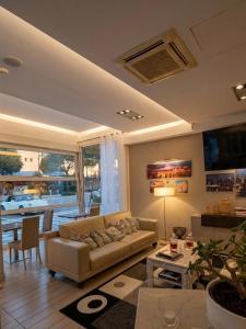 a living room with a couch and a table at Hotel Fiamma & SPA Cesenatico in Cesenatico