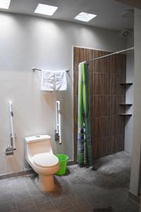 a bathroom with a toilet and a shower at Departamento Loro in Manzanillo