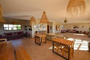 a living room with a couch and a table at Tassourt Lodge in Essaouira