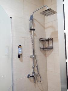 a shower with a shower head in a bathroom at Casa do Chafariz - Guest House in Cercal +28 photos