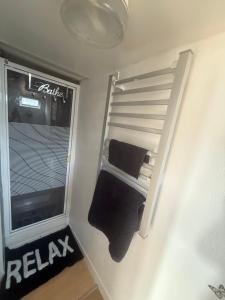 a small room with a ladder next to a window at The Butterfly in Leysdown-on-Sea