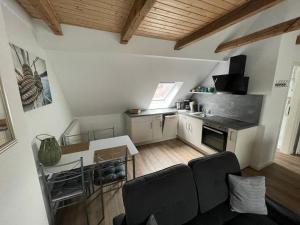a kitchen with a table and chairs in a room at Logger in Emden
