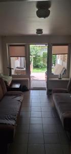 a living room with a couch and two windows at U Julii 2 in Okuninka