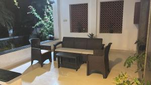 a patio with a table and a table and chairs at Villa Grand Classic in Covelong